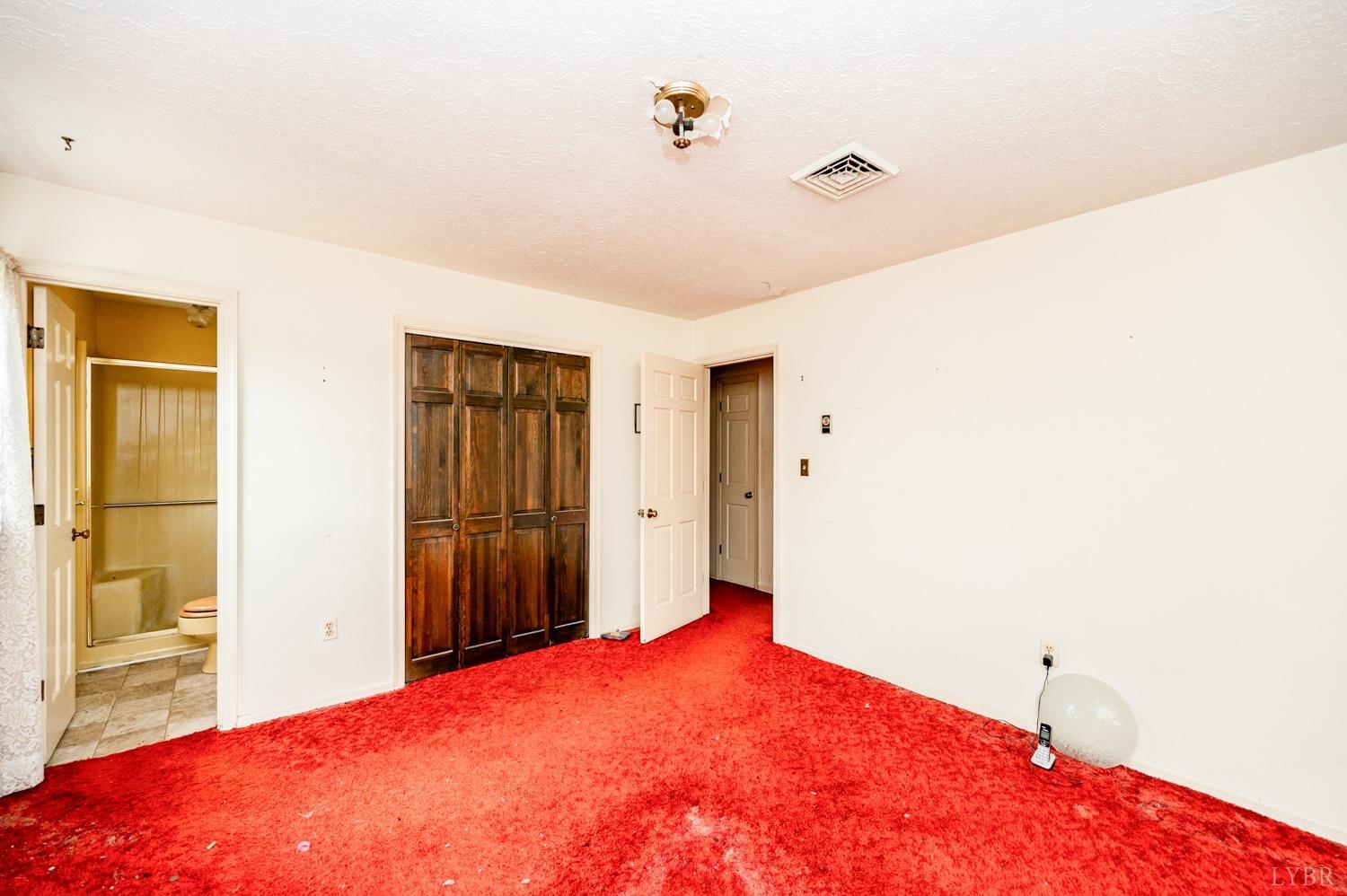 182 Buffalo Ridge Road Amherst, VA 24521 - Photo 16 of 57 a bedroom with a bed and a table