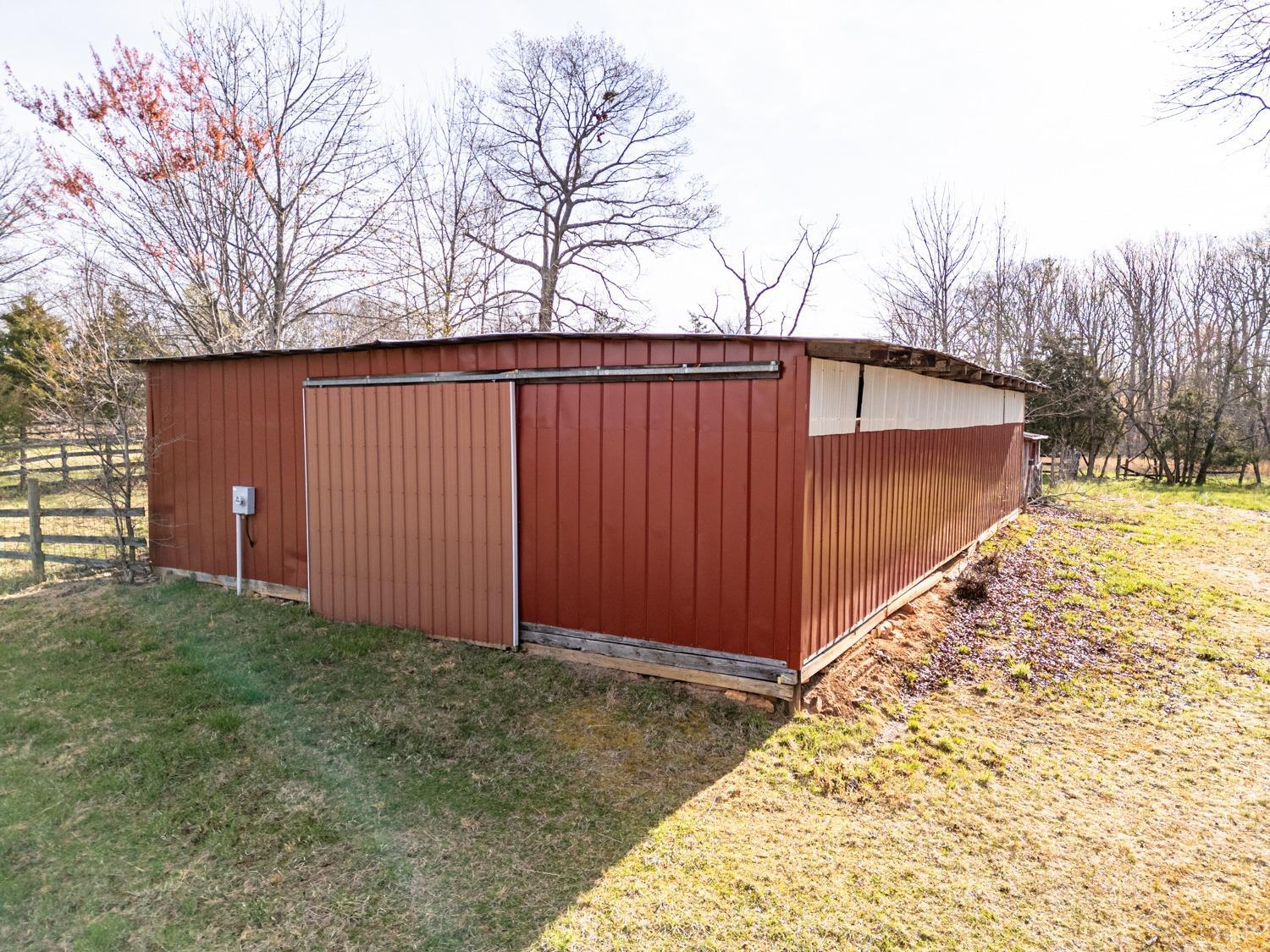 182 Buffalo Ridge Road Amherst, VA 24521 - Photo 5 of 57 a backyard of a house with trees and covered with wooden fence