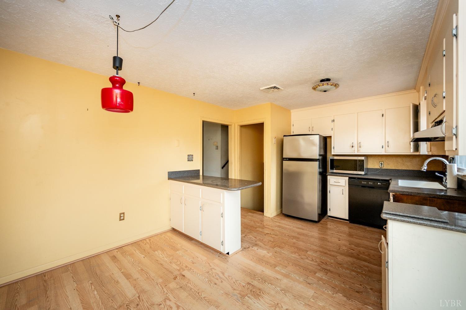182 Buffalo Ridge Road Amherst, VA 24521 - Photo 9 of 57 a kitchen with refrigerator and cabinets