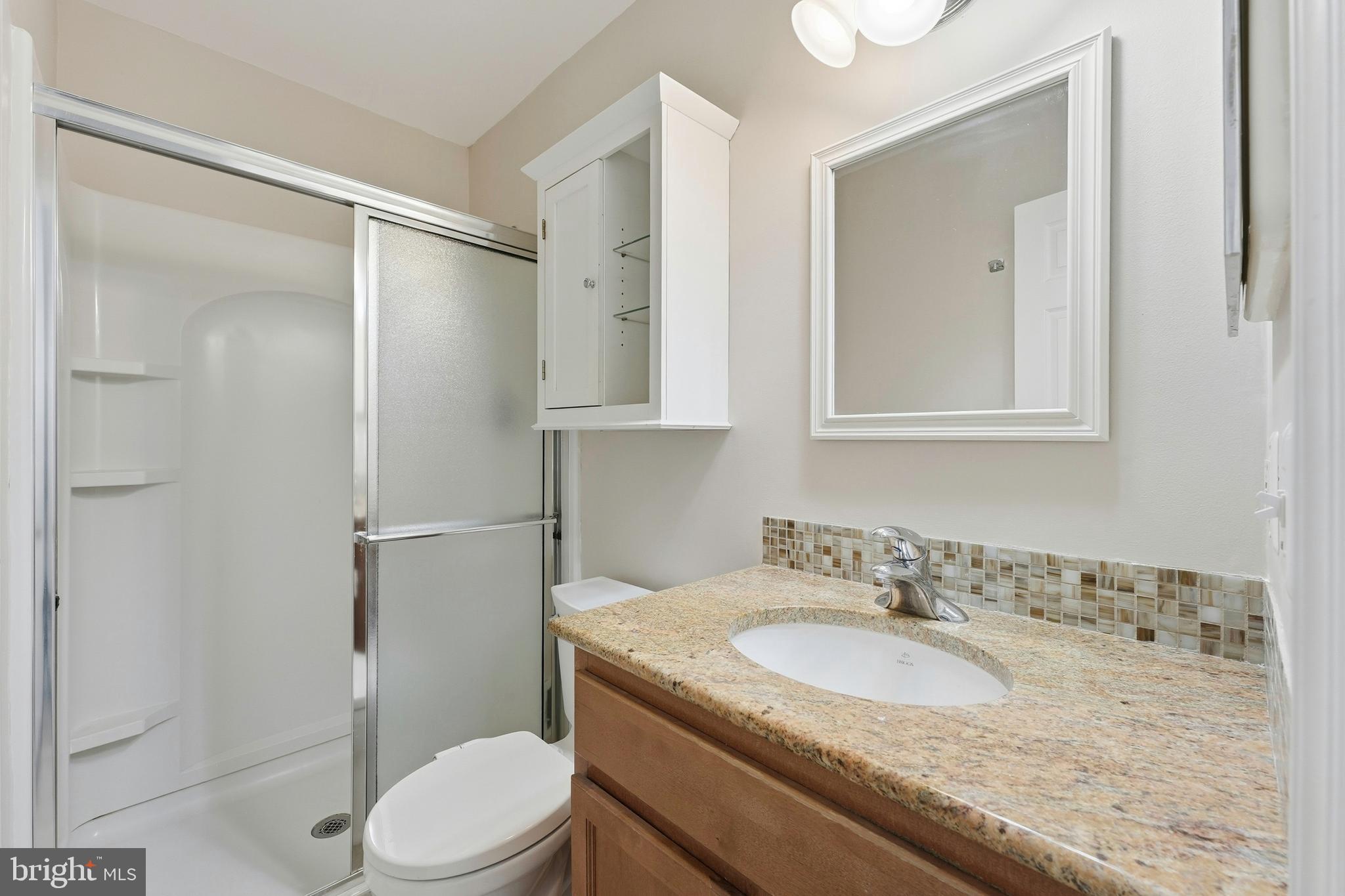 6036 Old Landing Way, Unit 29 Burke, VA 22015 - Photo 17 of 31 a bathroom with a granite countertop sink toilet and shower