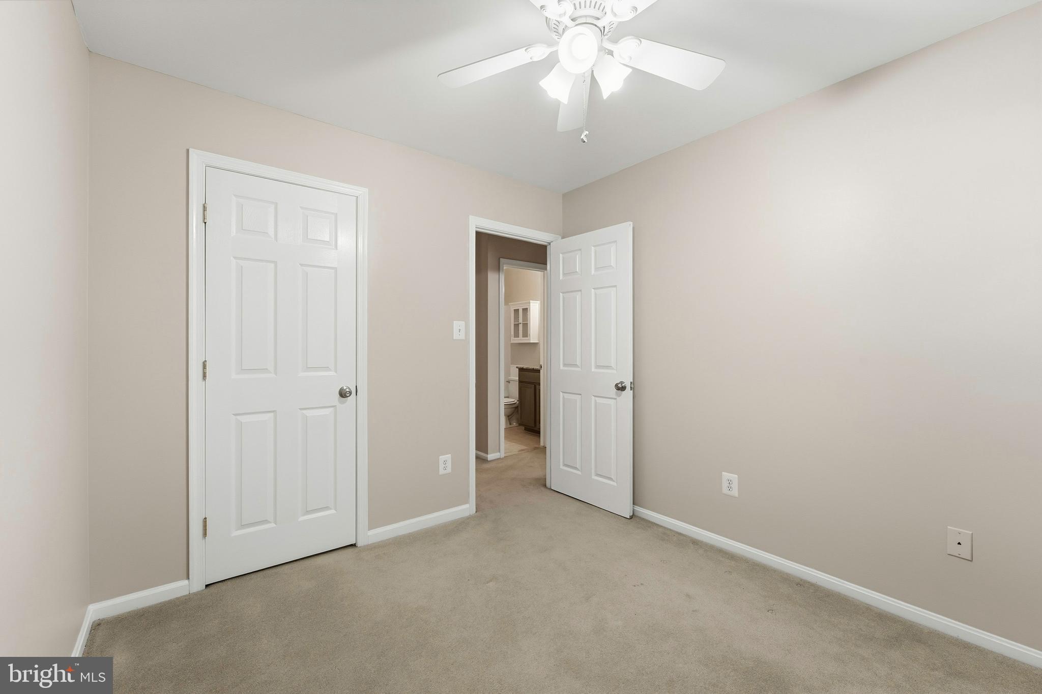 6036 Old Landing Way, Unit 29 Burke, VA 22015 - Photo 21 of 31 an empty room with a chandelier fan and closet area