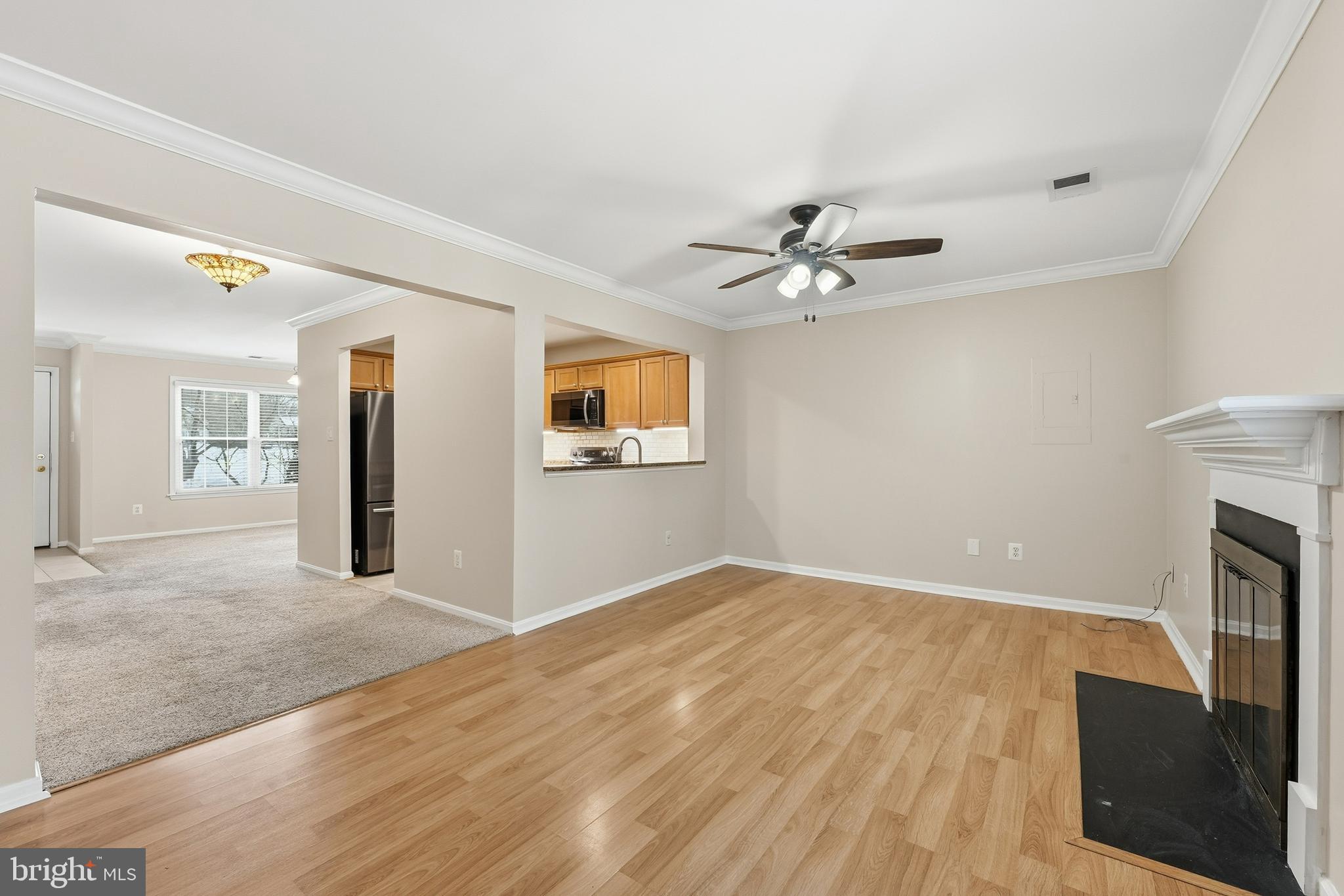 6036 Old Landing Way, Unit 29 Burke, VA 22015 - Photo 6 of 31 wooden floor in an empty room with a fireplace