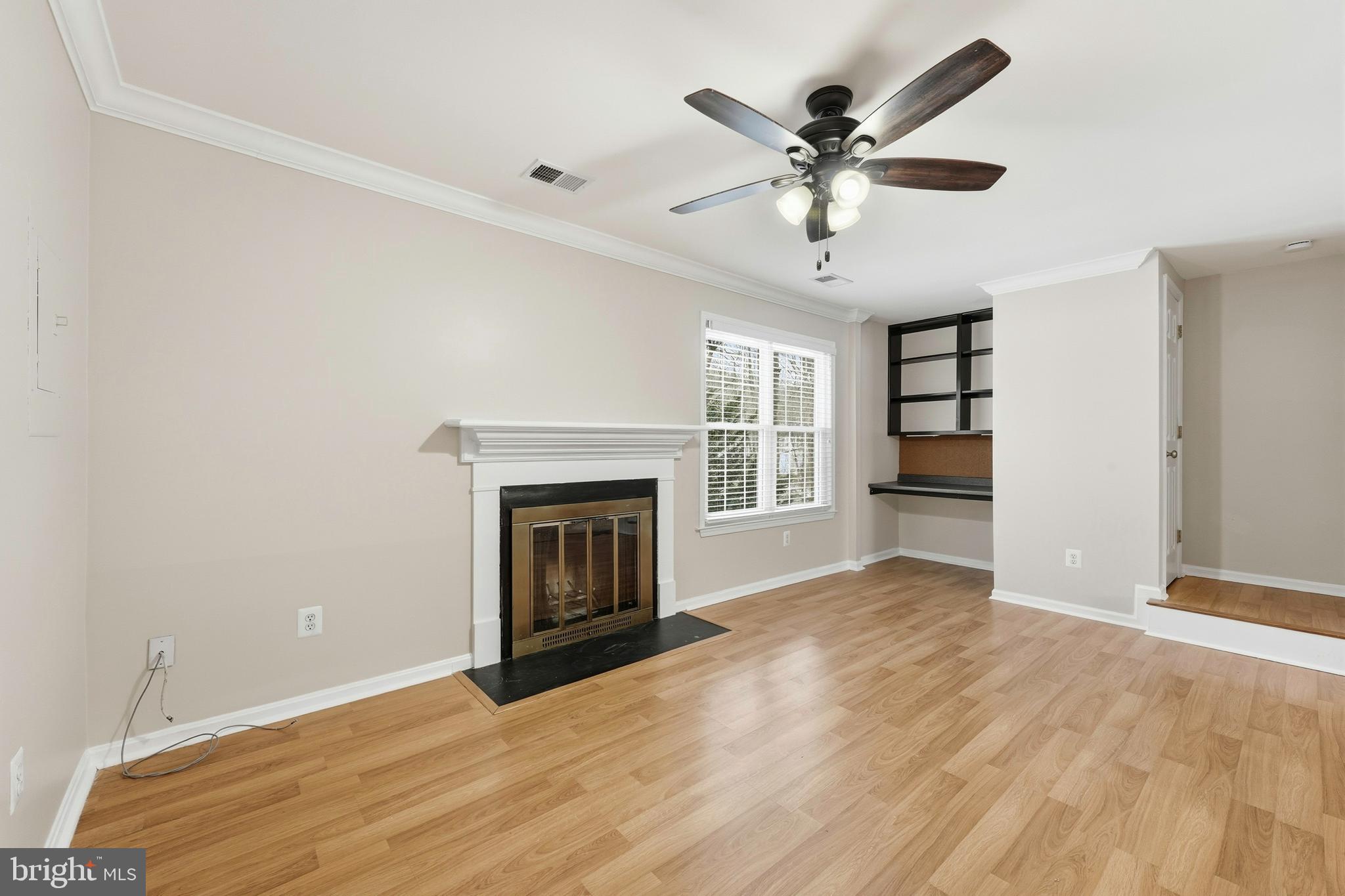 6036 Old Landing Way, Unit 29 Burke, VA 22015 - Photo 7 of 31 an empty room with fireplace and ceiling fan