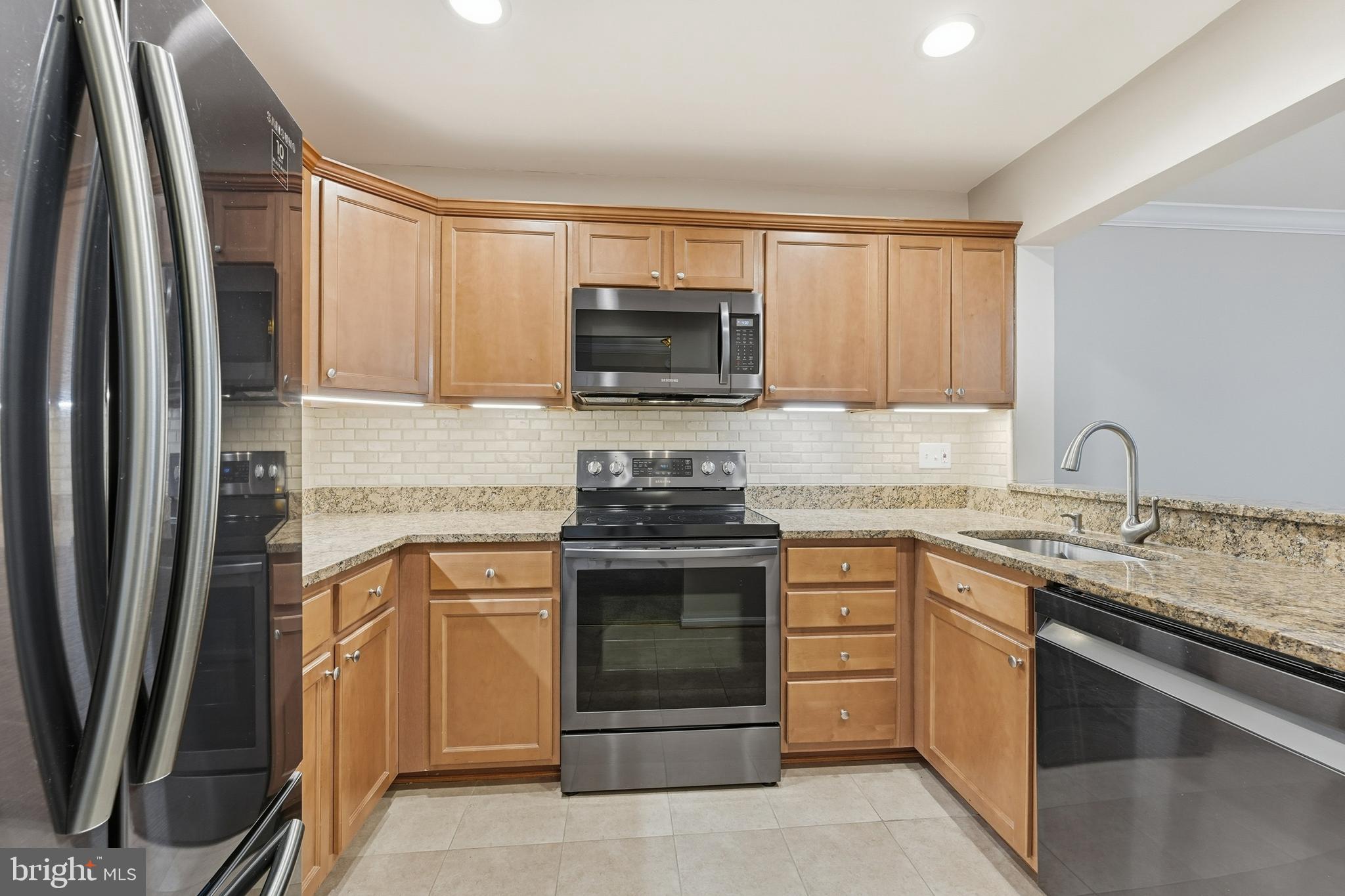 6036 Old Landing Way, Unit 29 Burke, VA 22015 - Photo 8 of 31 a kitchen with a stove and a sink