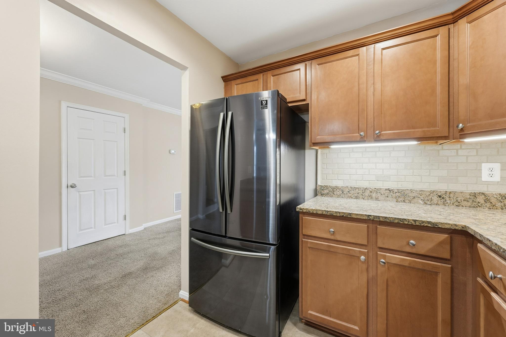 6036 Old Landing Way, Unit 29 Burke, VA 22015 - Photo 10 of 31 a kitchen with stainless steel appliances granite countertop a refrigerator and a sink