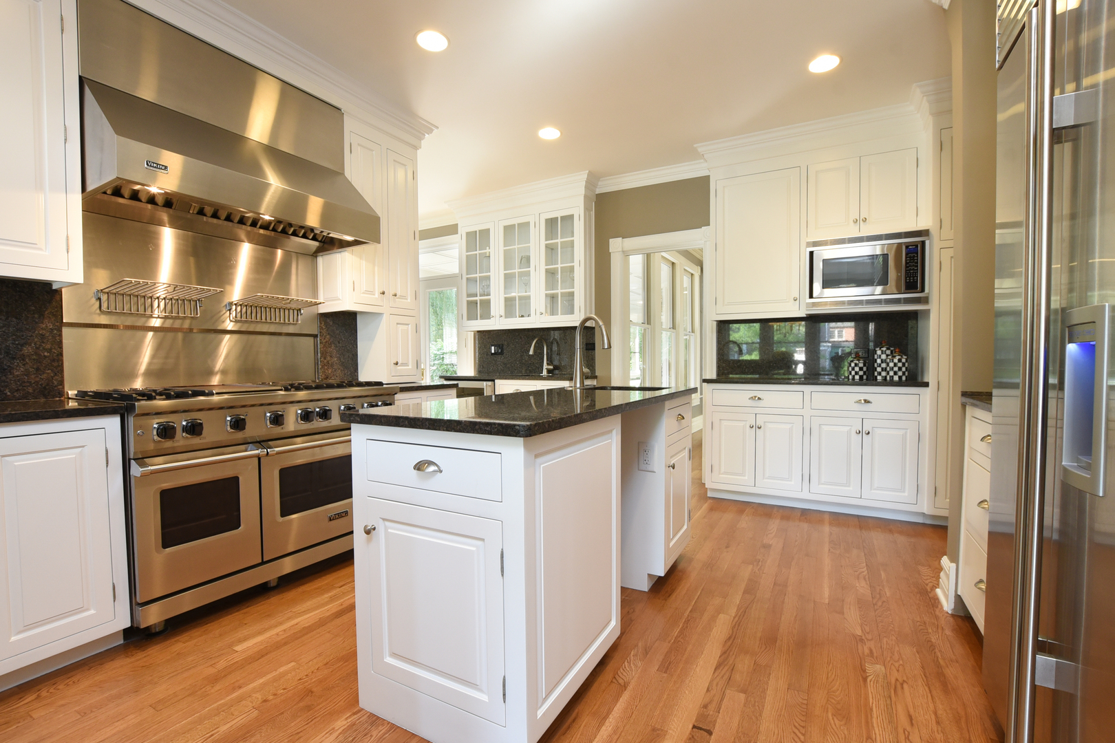 300 North Delaplaine Road Riverside, IL 60546 - Photo 15 of 50 a kitchen with stainless steel appliances kitchen island granite countertop a stove and a sink