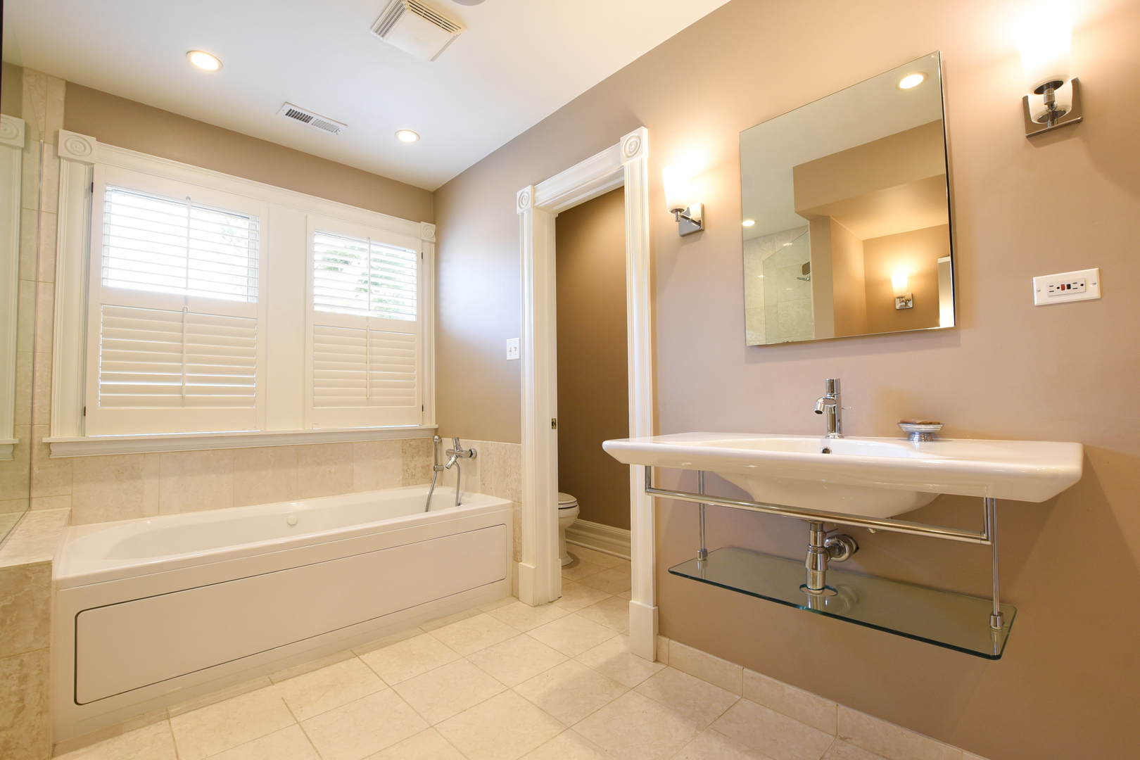 300 North Delaplaine Road Riverside, IL 60546 - Photo 30 of 50 a bathroom with a tub sink and mirror