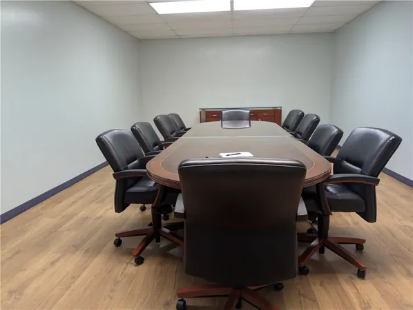 a view of a workspace with furniture and wooden floor