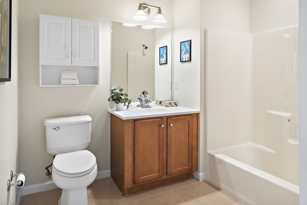 107 Clocktower Drive, Unit 303 Waltham, MA 02452 - Photo 15 of 18 a bathroom with a sink toilet and shower