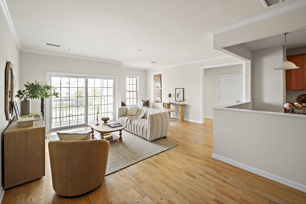107 Clocktower Drive, Unit 303 Waltham, MA 02452 - Photo 3 of 18 a living room with furniture and a large window