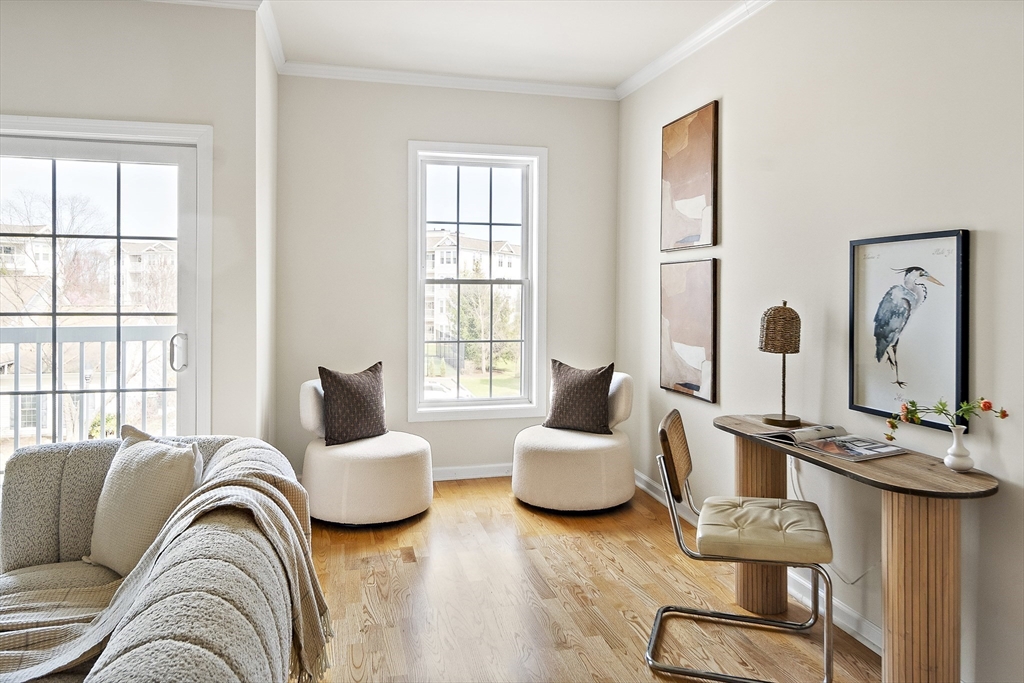 107 Clocktower Drive, Unit 303 Waltham, MA 02452 - Photo 4 of 18 a living room with furniture and windows