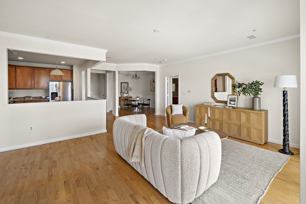 107 Clocktower Drive, Unit 303 Waltham, MA 02452 - Photo 5 of 18 a living room with furniture and wooden floor