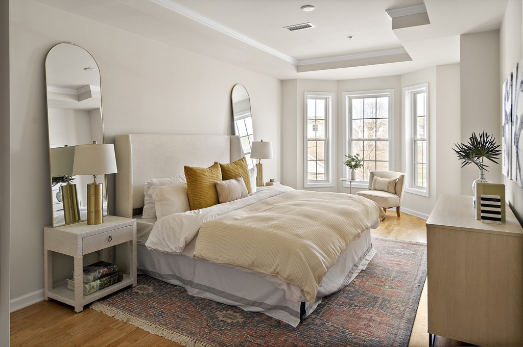 107 Clocktower Drive, Unit 303 Waltham, MA 02452 - Photo 10 of 18 a bed room with a bed and a potted plant