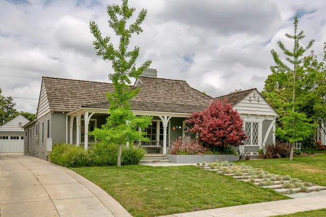 a front view of a house with a garden