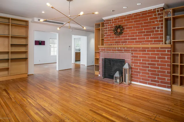a view of a livingroom with a fireplace and wooden floor