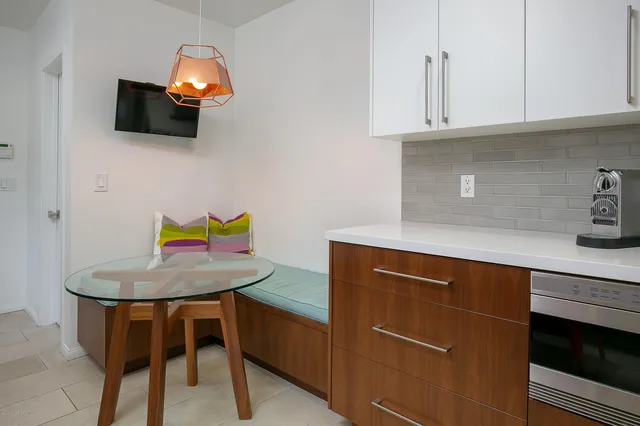 a kitchen with a sink a microwave and cabinets