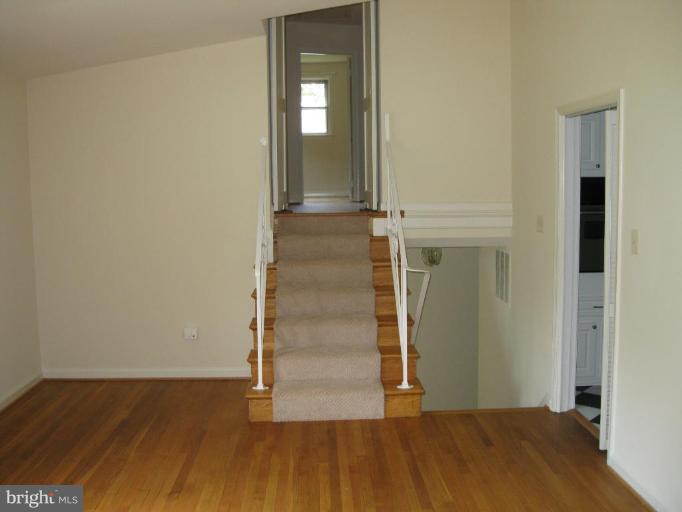 8209 Beech Tree Road Bethesda, MD 20817 - Photo 10 of 20 Living room with stairs to upper and main level.