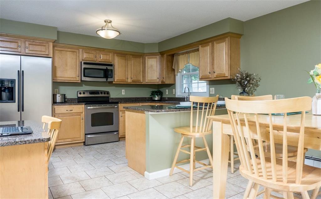 a kitchen with a stove a sink and a microwave