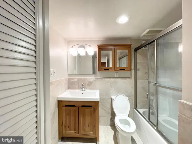 a bathroom with a double vanity sink mirror and shower