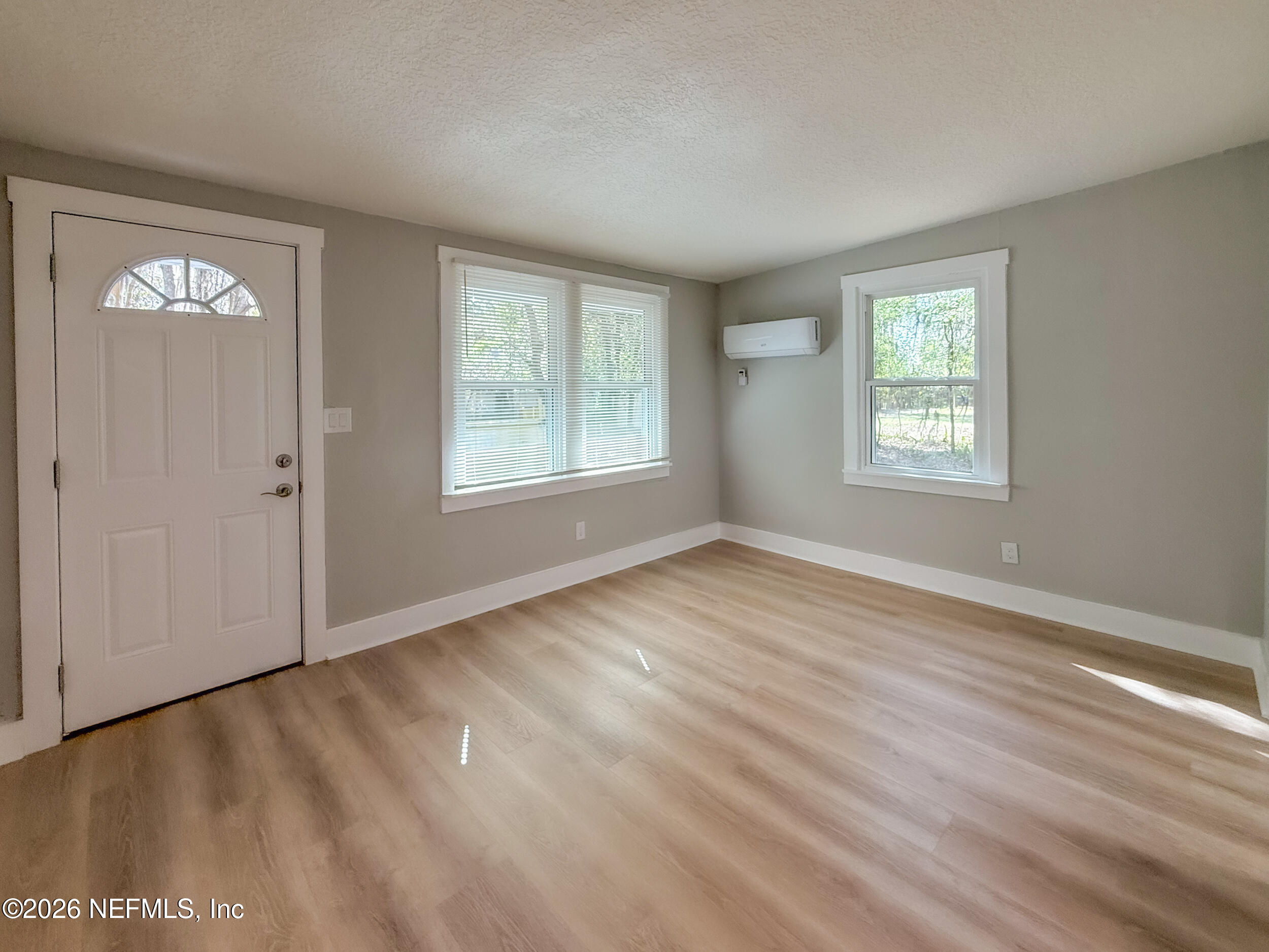 6304 Blanchard Road Jacksonville, FL 32216 - Photo 4 of 15 a view of an empty room with wooden floor and a window