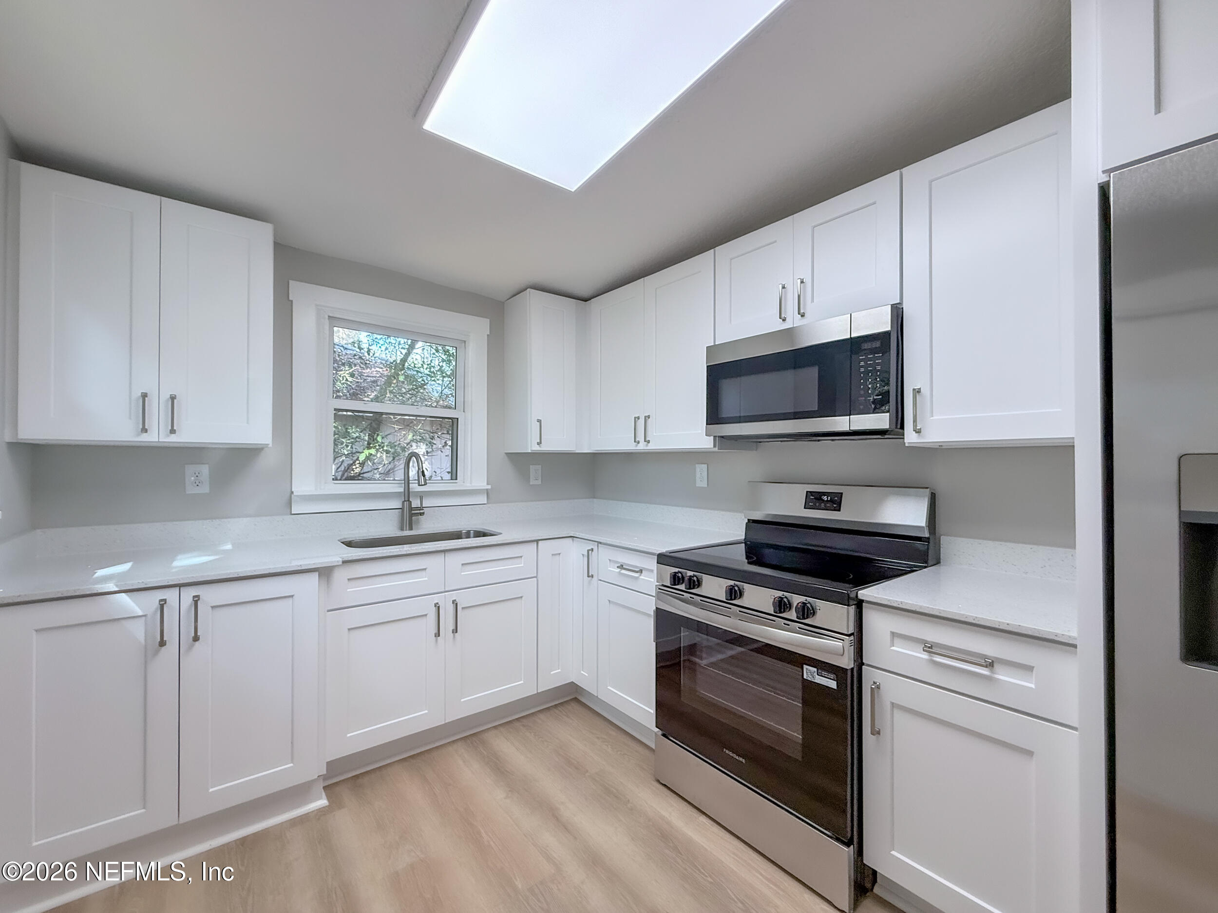 6304 Blanchard Road Jacksonville, FL 32216 - Photo 8 of 15 a kitchen with cabinets stainless steel appliances a sink and a window