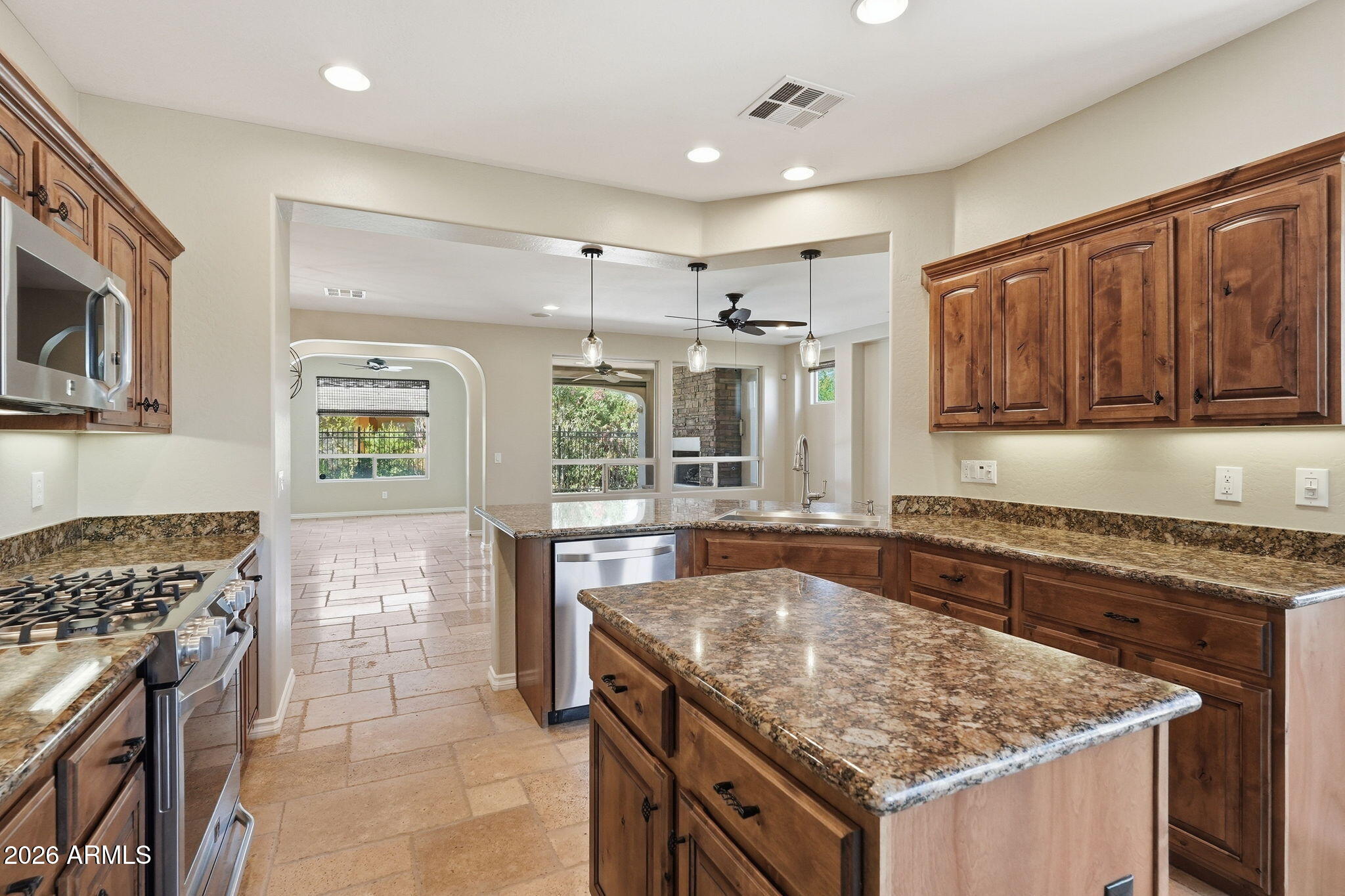 1694 East Grand Ridge Road Queen Creek, AZ 85140 - Photo 17 of 61 a kitchen with stainless steel appliances granite countertop a stove a sink and a microwave