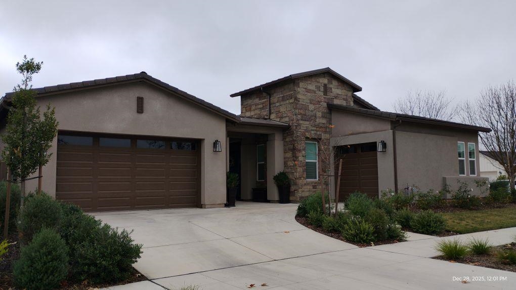 965 Beaver Pond Loop Madera, CA 93636 - Photo 1 of 5 a front view of a house with a yard