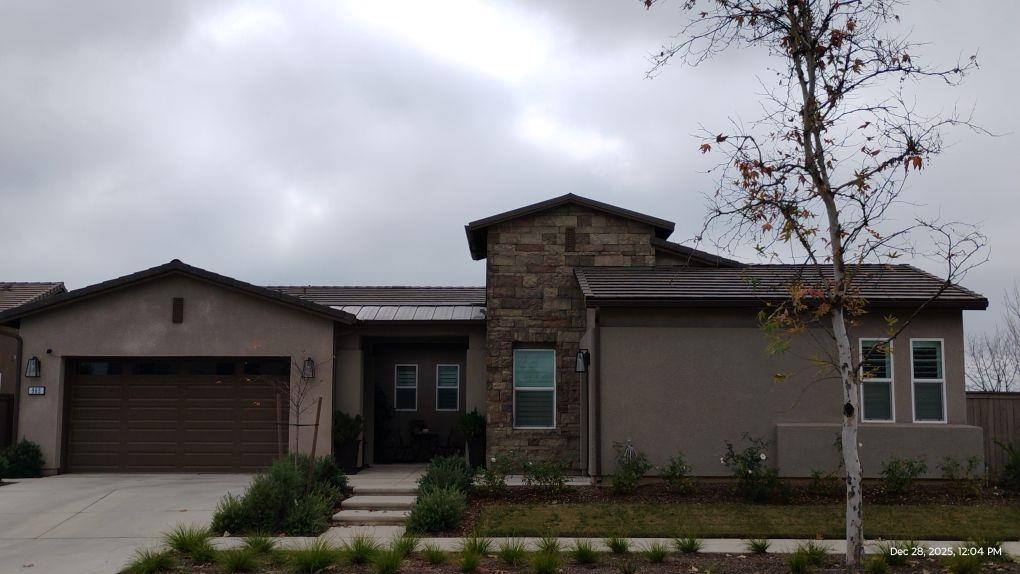 965 Beaver Pond Loop Madera, CA 93636 - Photo 2 of 5 a front view of a house with garden