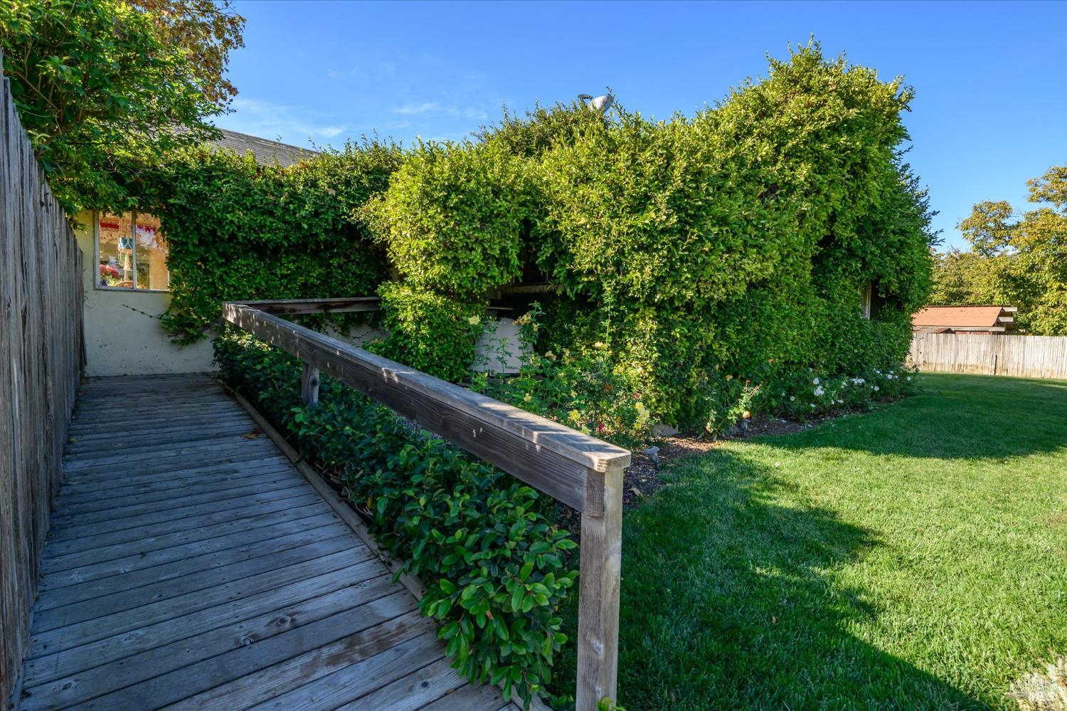 5430 Putah Creek Road Winters, CA 95694 - Photo 28 of 99 a balcony with wooden floor and trees in the back