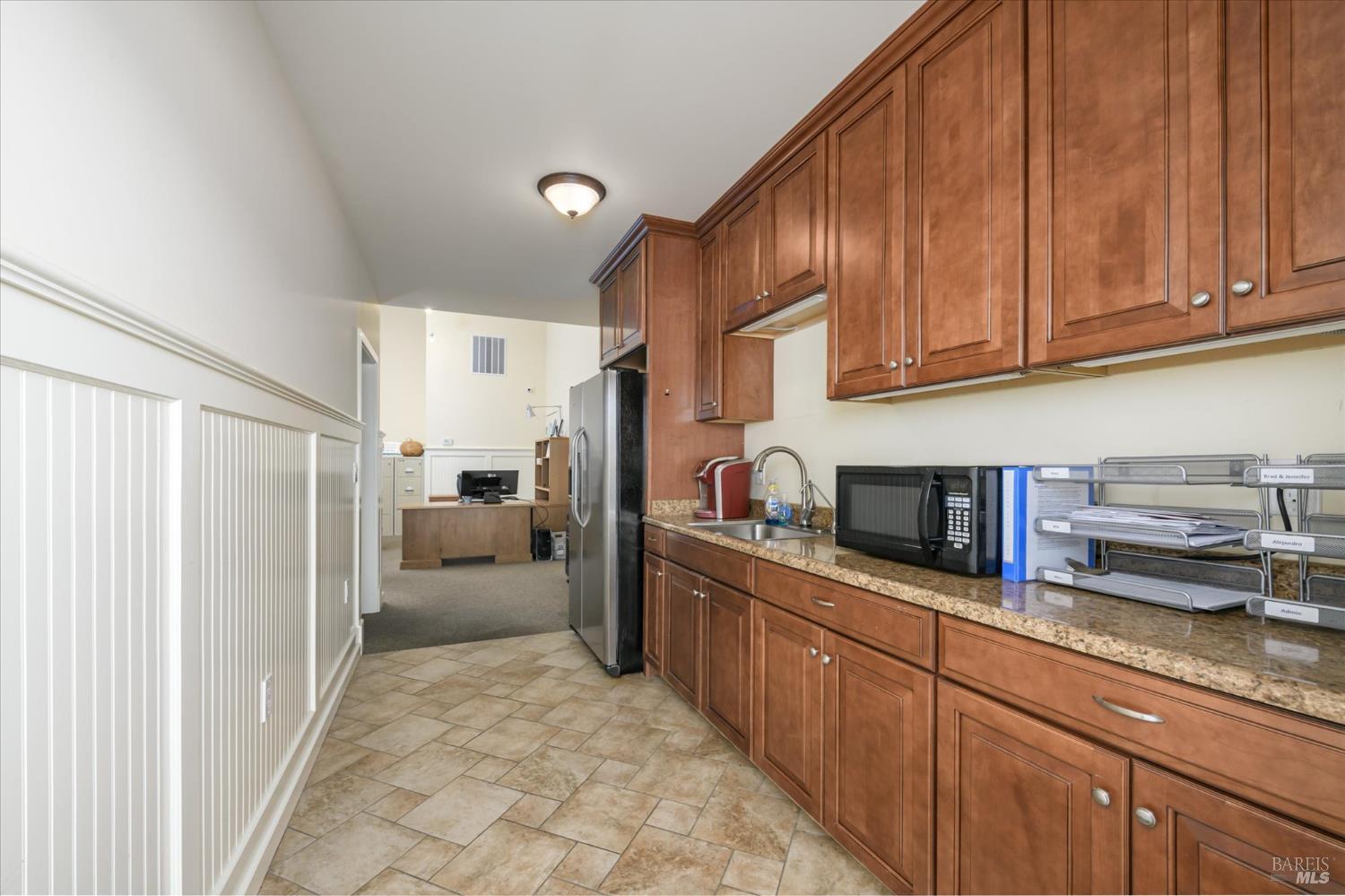 5430 Putah Creek Road Winters, CA 95694 - Photo 58 of 99 a kitchen with stainless steel appliances granite countertop a refrigerator sink and cabinets