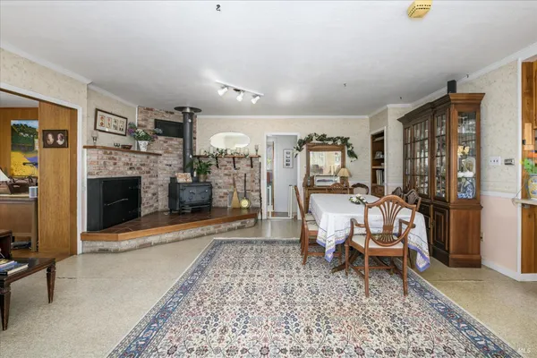 a bedroom with a bed a flat screen tv and dresser