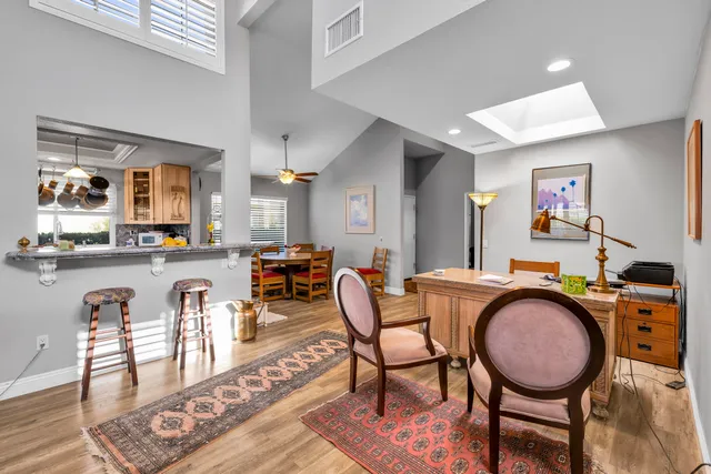 a dining room with furniture and wooden floor