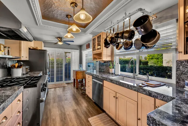 a kitchen with stainless steel appliances a stove a sink and a refrigerator