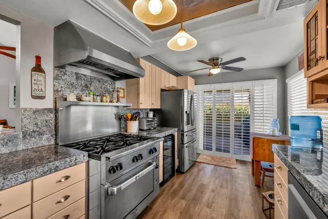a kitchen with stainless steel appliances granite countertop a stove and cabinets