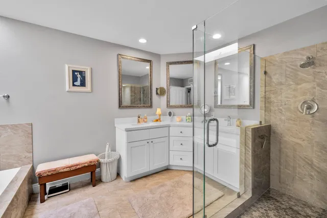a spacious bathroom with a shower sink and mirror