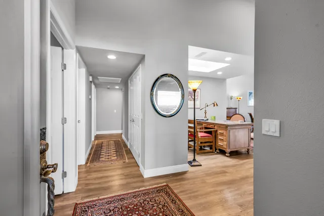 a view of a hallway and a livingroom with furniture