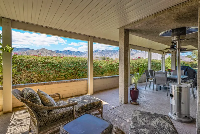 a living room with furniture and a floor to ceiling window