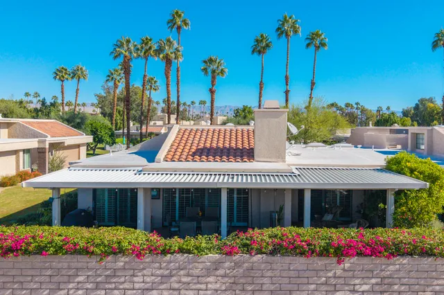 a view of a patio with table and chairs and potted plants