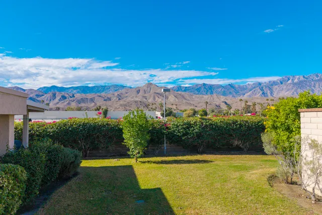 a view of a swimming pool with an outdoor space and seating area