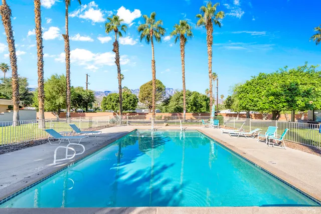 a view of a swimming pool with a yard and mountain view