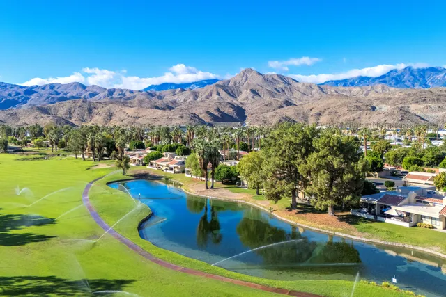 a view of a house with pool and a garden