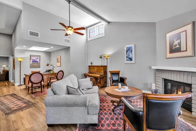 a living room with furniture a rug and a fireplace