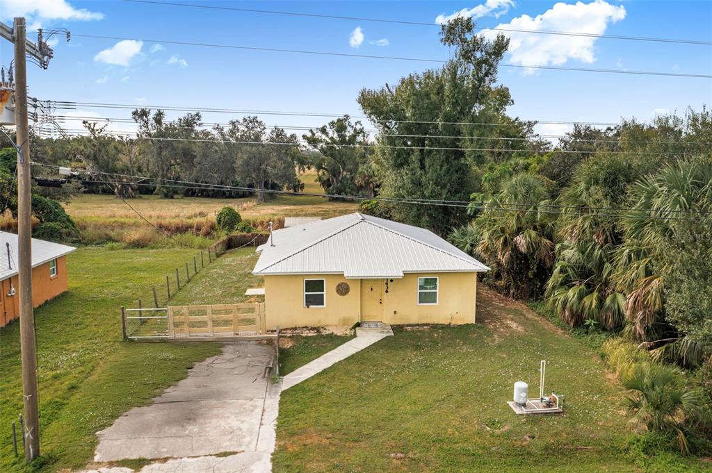 a aerial view of a house with swimming pool and a yard