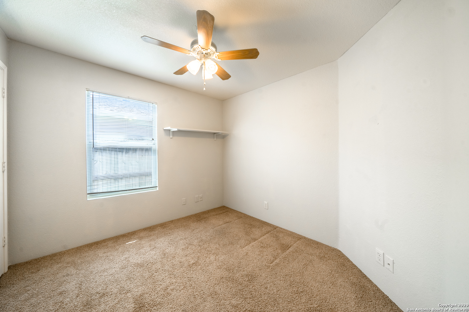 7907 M G Road San Antonio, TX 78251 - Photo 11 of 19 an empty room with a window and a fan