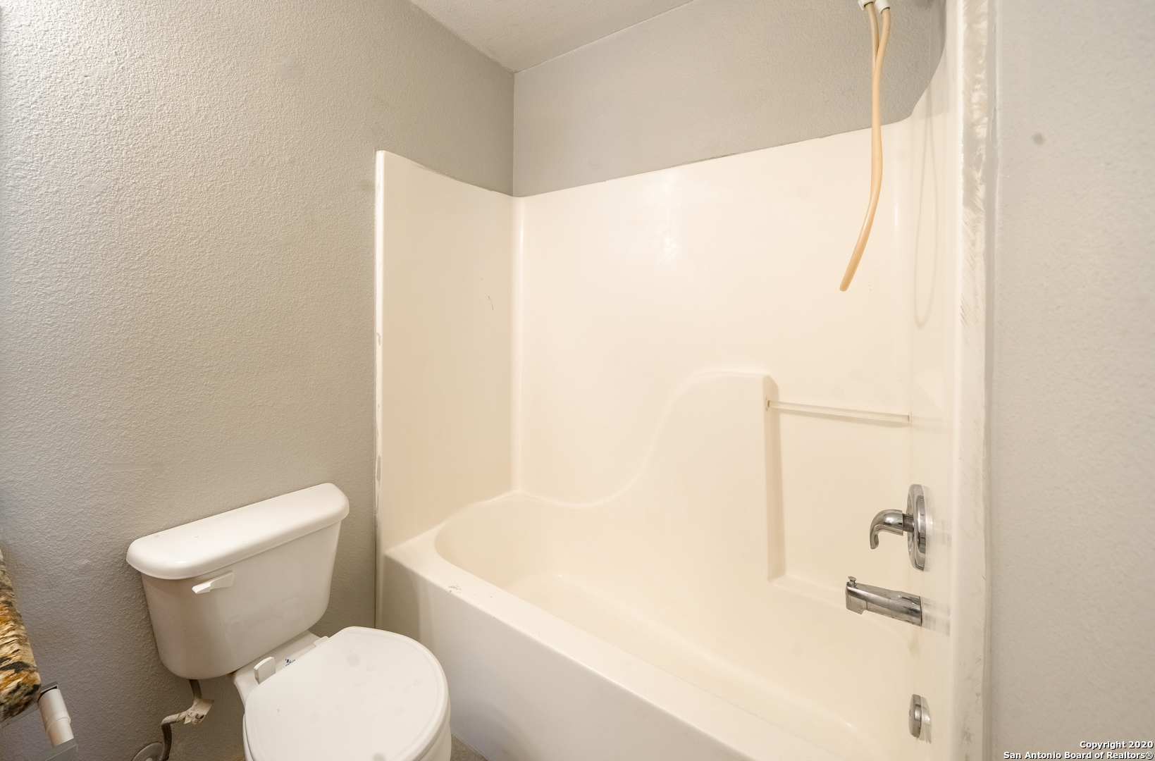 7907 M G Road San Antonio, TX 78251 - Photo 14 of 19 a white toilet sitting next to a bathroom sink and tub