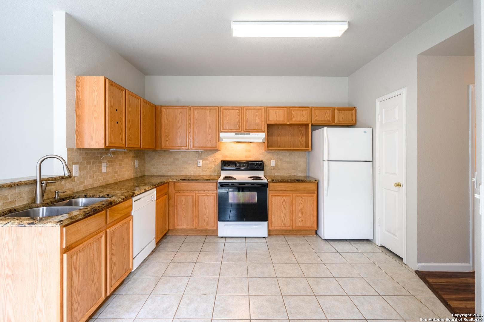 7907 M G Road San Antonio, TX 78251 - Photo 7 of 19 a kitchen with stainless steel appliances granite countertop a stove a sink and a refrigerator