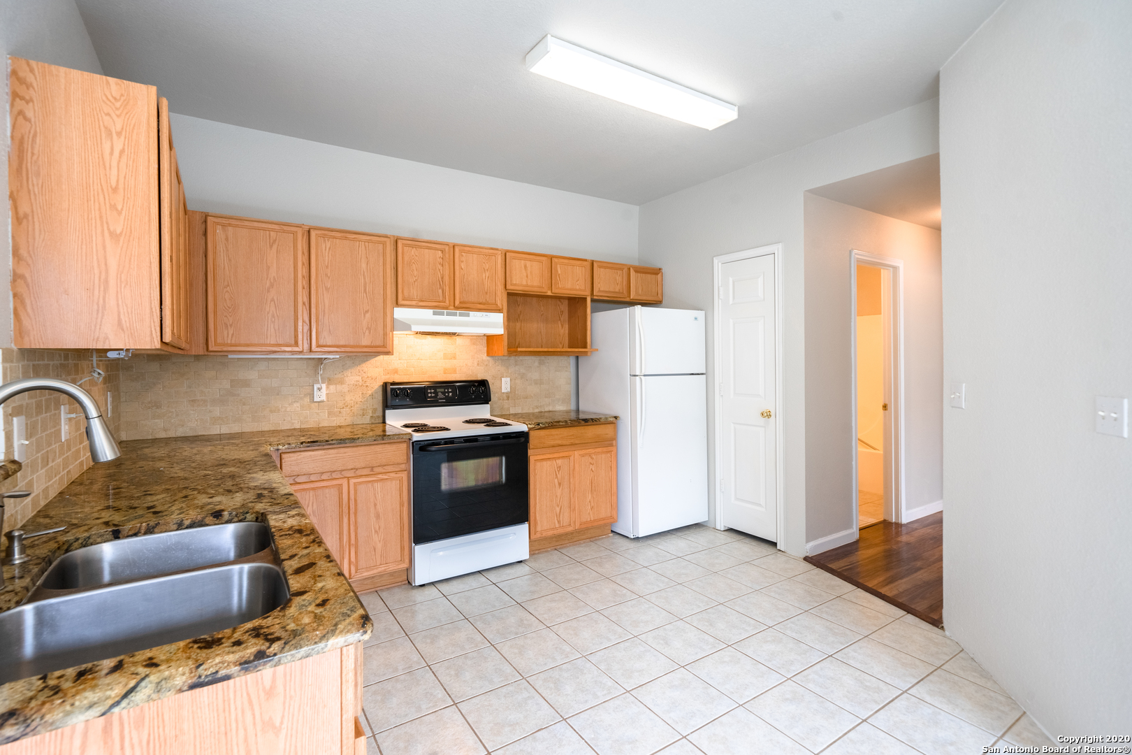 7907 M G Road San Antonio, TX 78251 - Photo 8 of 19 a kitchen with stainless steel appliances granite countertop a refrigerator and a stove top oven