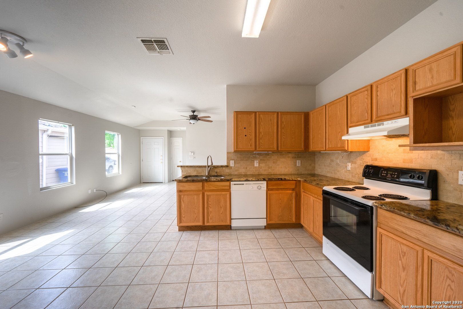 7907 M G Road San Antonio, TX 78251 - Photo 10 of 19 a kitchen with stainless steel appliances granite countertop a stove sink and cabinets
