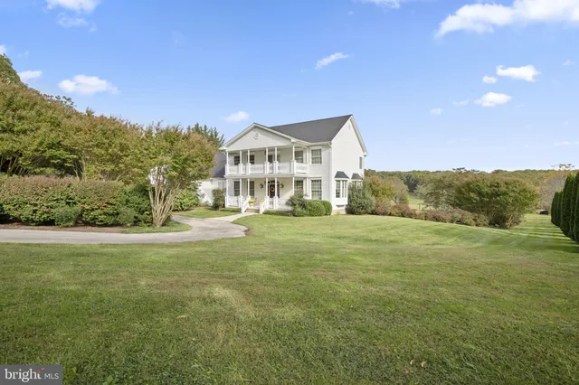 a view of an house with backyard space and balcony