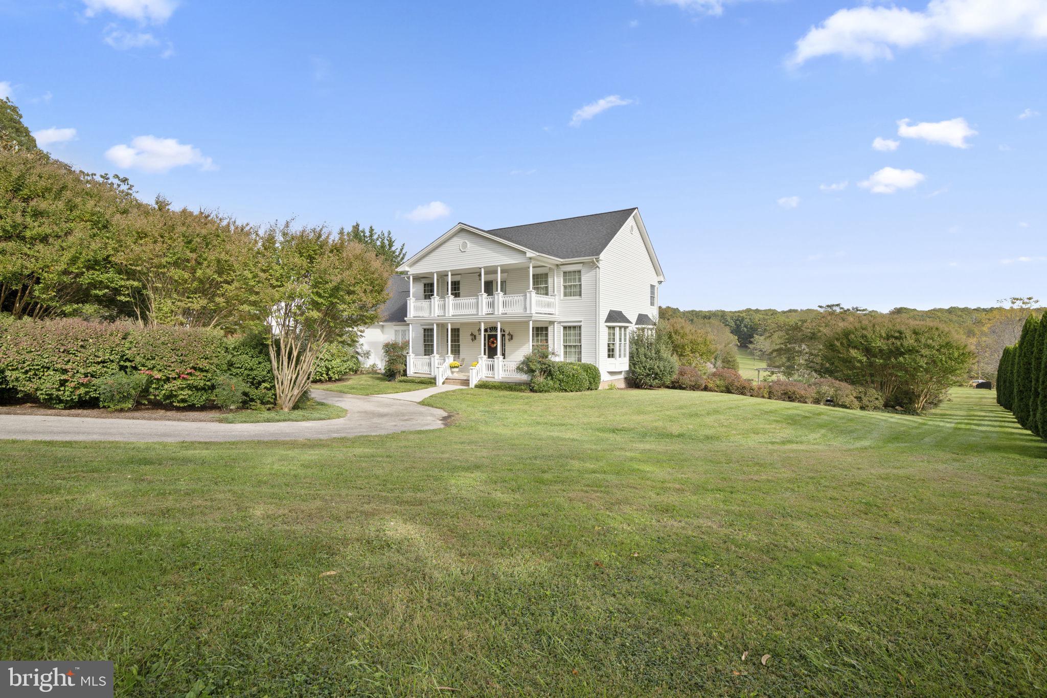 a view of an house with backyard space and balcony